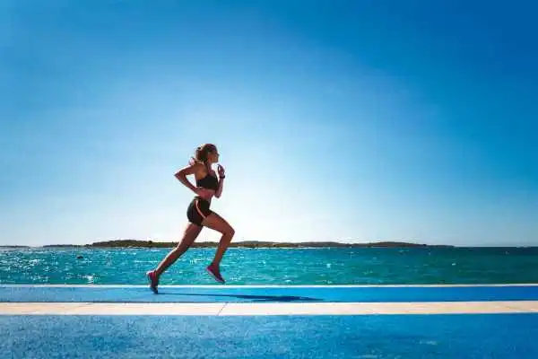 Woman running showing strong leg muscle Esher